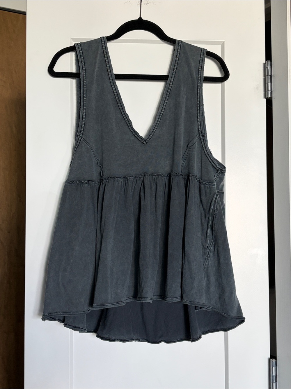 Free People movement baby doll tank with cross strappy details and pockets!